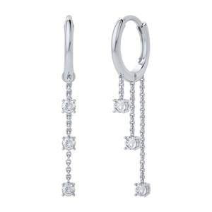 Detail of silver drop earrings with three round-cut cubic zirconia on delicate chains