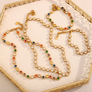 Macro detail of 18K gold plated stainless steel jewelry set with colorful gemstones