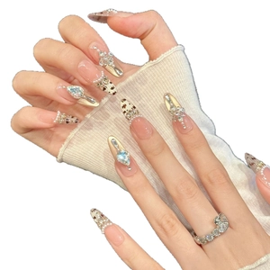 Pink leopard press-on nails with pearls and gold accents in an elegant almond shape
