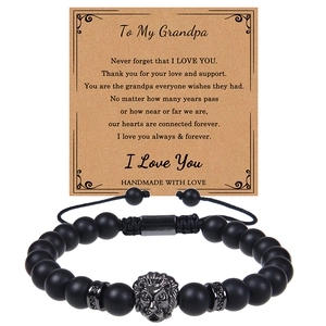 Detail of matte black onyx bracelet with lion head charm and gift card for grandpa