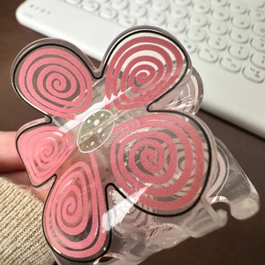 Floral hair claw clip with pink spiral petals and white polka dot center in macaron color