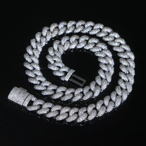 Macro shot of silver Cuban link chain with sparkling pavé crystals and secure box clasp