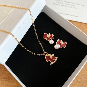 Detail of horse-shaped red enamel jewelry set with white pearls in a premium gift box