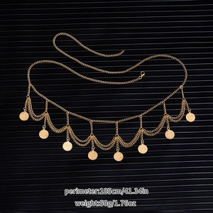 Detail of bohemian gold coin tassel waist chain with adjustable layered metal charms