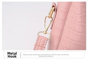 Detail of pink crocodile embossed leather tote with high-quality gold hardware plating