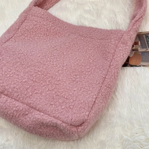 Close-up of pink curly faux shearling texture on a large autumn winter tote bag