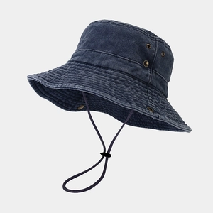 Detail of wide brim bucket hat in washed navy cotton with adjustable black wind cord