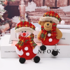 Close-up of plush snowman and bear Christmas ornaments with festive plaid hats and scarves