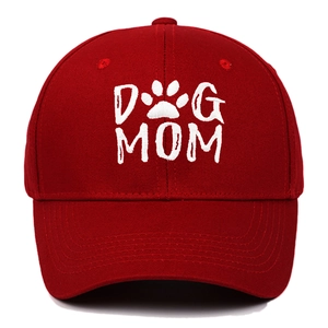Close-up of white 3D embroidered DOG MOM text and paw print on red cotton baseball cap