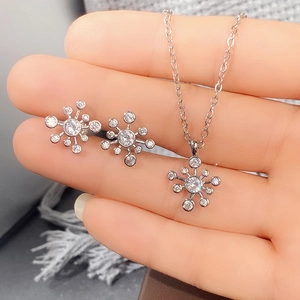 Nahaufnahme von silbernem Schneeflocken-Schmuckset mit funkelnden weißen Zirkonia-Steinen