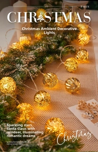 Detail of warm LED Christmas string lights with golden hollow geometric metal balls