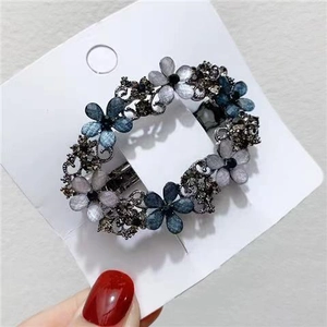 Vintage hollow alloy hair clip with blue rhinestone flower and luxury metal spring clip