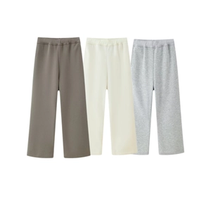 Flat lay detail of three-pack kids' sweatpants in dark brown, cream, and light grey