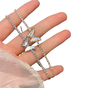 Elegant butterfly charm bracelet with sparkling crystals and iridescent shell finish