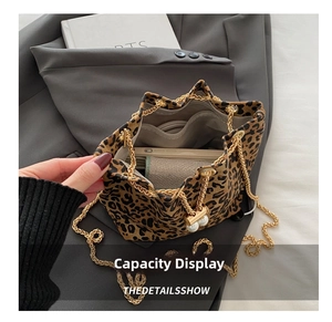Detailed interior view of leopard print bucket bag with gold chain and large capacity