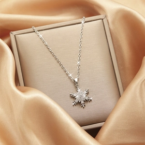 Close-up of sparkling zircon snowflake pendant on an elegant silk jewelry box