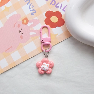 Close-up of a pink flower rabbit keychain with metal lobster clasp and sweet floral design