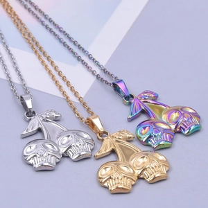Close-up of three skull cherry necklaces in silver, gold and rainbow electroplated finish