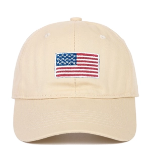 Close-up of American flag embroidery on khaki cotton baseball cap with twill texture