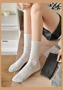 Detailed knit texture of combed cotton crew socks in white, dark grey and light grey