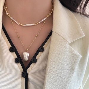 Baroque pearl layered necklace set with gold beads and large irregular pendant on model