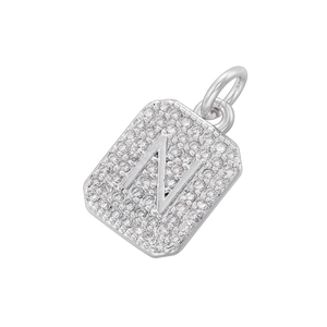 Macro detail of silver square pendant with micro-pave letter N and clear cubic zirconia