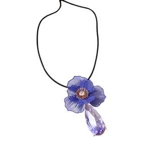 Wax cord necklace with blue metal flower and purple crystal pendant set on white background