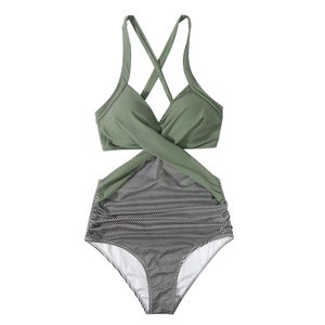Detail of cross-wrap neckline and olive green contrast panel on striped swimsuit