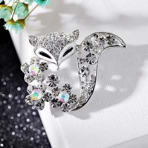 Detailed macro view of silver fox brooch with inlaid crystals and colorful flowers