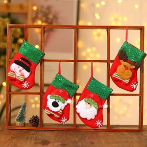 Set of 4 Christmas stockings with snowman and reindeer hanging on a wooden rack