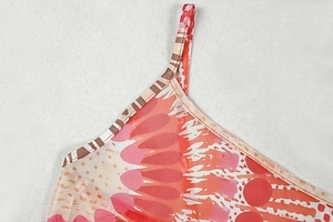Close-up of orange and pink mesh fabric with durable neckline stitching and thin straps