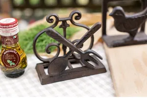 Detail view of rustic cast iron tissue holder with bird and cutlery motifs for kitchen decor