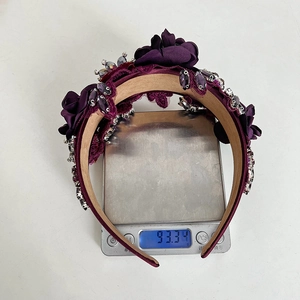 Detailed top view of luxury wide headband with rhinestones and 3D floral embroidery