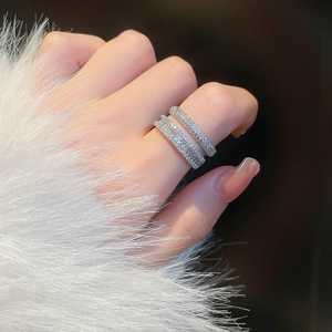 Detailed view of double-layered silver ring with cubic zirconia on a model's hand