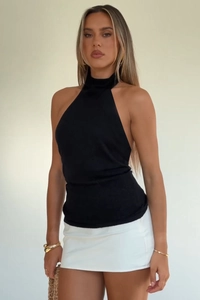 Detailed view of black halter neck knitted top with slim fit and elegant shoulder design