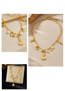 Detail of gold starfish, seahorse, and shell charms with faux pearls on a chain necklace