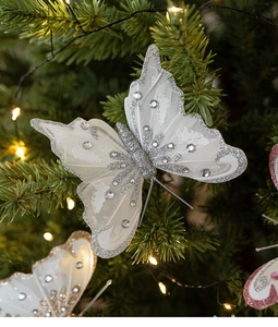 Detail eines silbernen Pailletten-Schmetterlings mit Schmucksteinen am Weihnachtsbaum