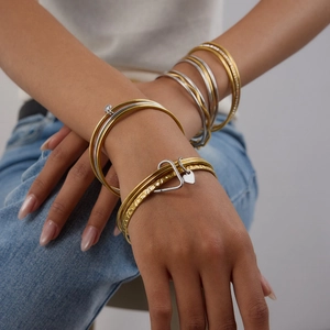 Multi-layered titanium steel bracelets in gold and silver finish on female model