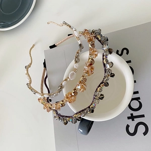 Detail of thin crystal headbands with shimmering glass beads and pearls on metal bands
