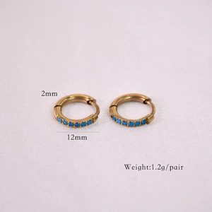 Detail of 12mm gold stainless steel hoop earrings with blue micro-inlaid stones