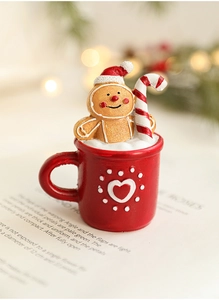 Macro shot of resin Christmas mug figurine with gingerbread man and candy cane detail