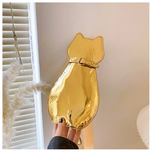 Detailed view of the gold cat-shaped crossbody bag in glossy patent leather finish