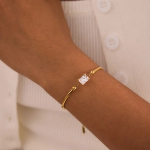 Macro view of a gold-plated stainless steel bracelet with a rectangular zircon stone