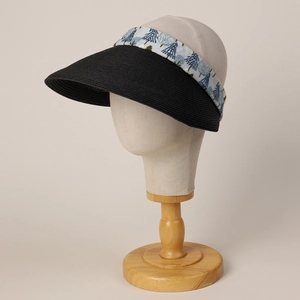 Detail of woven straw visor with Nordic pine pattern headband on a mannequin