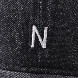 Close-up of vintage washed grey baseball cap with high-quality white 3D letter N embroidery