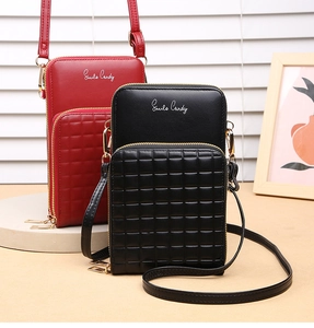 Detail of quilted cross-body phone bags in red and black with Smile Candy print