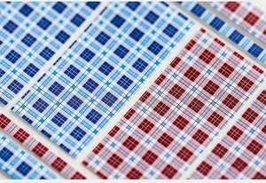 Macro detail of 5D blue and red Scottish plaid nail stickers with thin adhesive backing