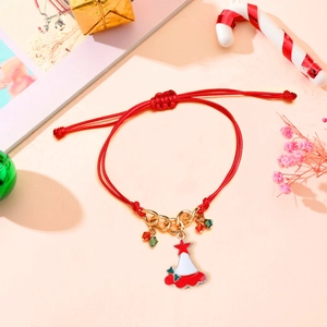 Detail of red braided Christmas bracelet with festive hat pendant and gold chain