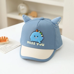 Detail of blue and white baby baseball cap with cartoon dinosaur patch and cute 3D ears