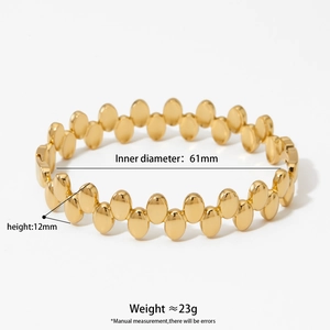 Golden stainless steel oval dot bangle with 61mm diameter and minimalist chic aesthetic